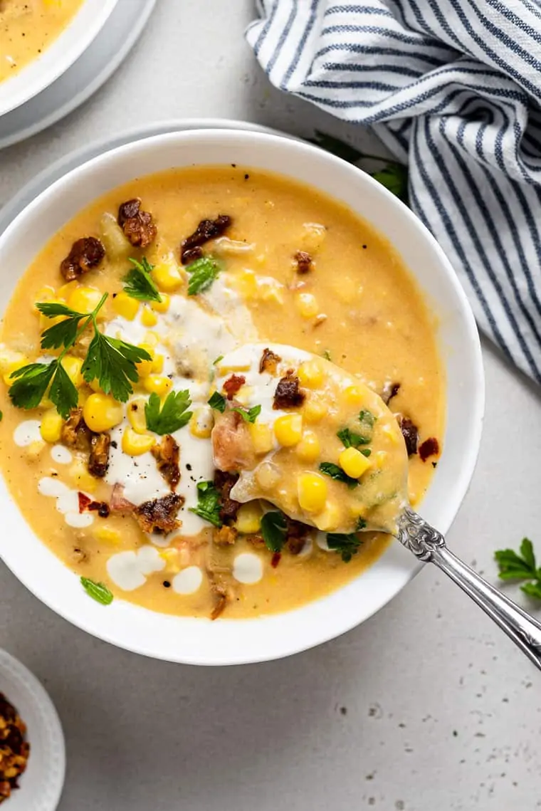 close up on a bowl of corn chowder with fresh corn and cashew cream