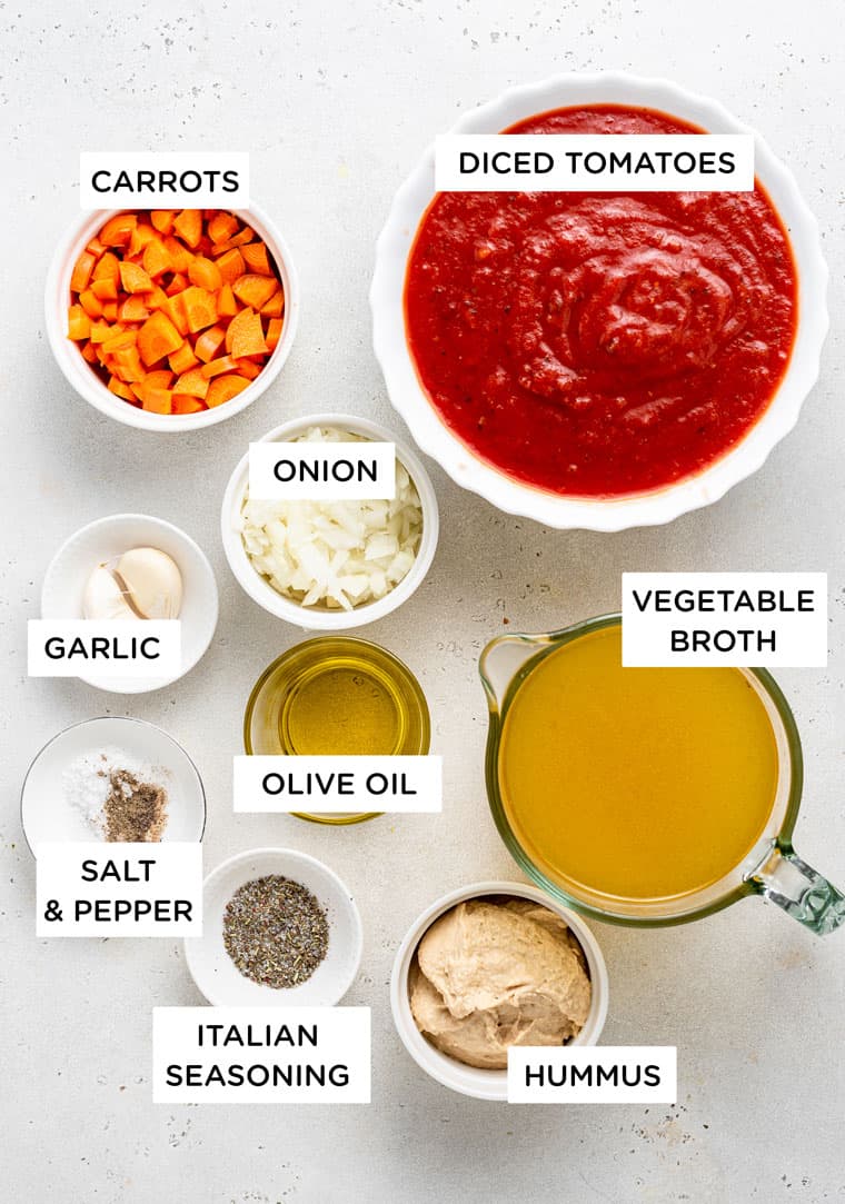 ingredients for soup with tomato, carrots, hummus and broth