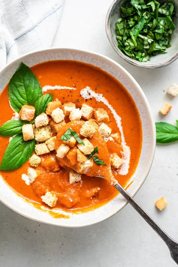 bowl of creamy tomato soup with croutons