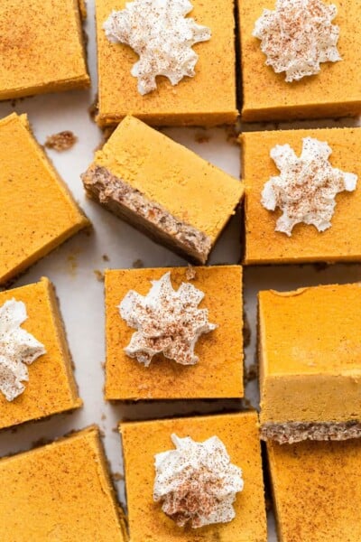 close up on creamy pumpkin bars with pecan crust