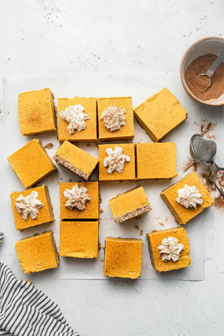 cut pumpkin cheesecake bars with pecan crust