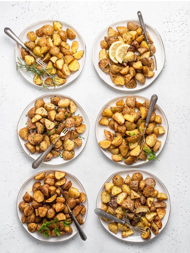 roasted potatoes on six plates