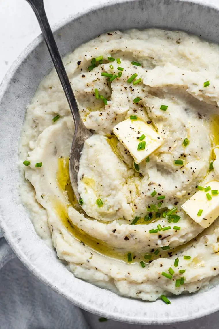 close up on mashed cauliflower with chives and butter