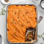 full baking dish of vegan shepherd's pie with a slice removed