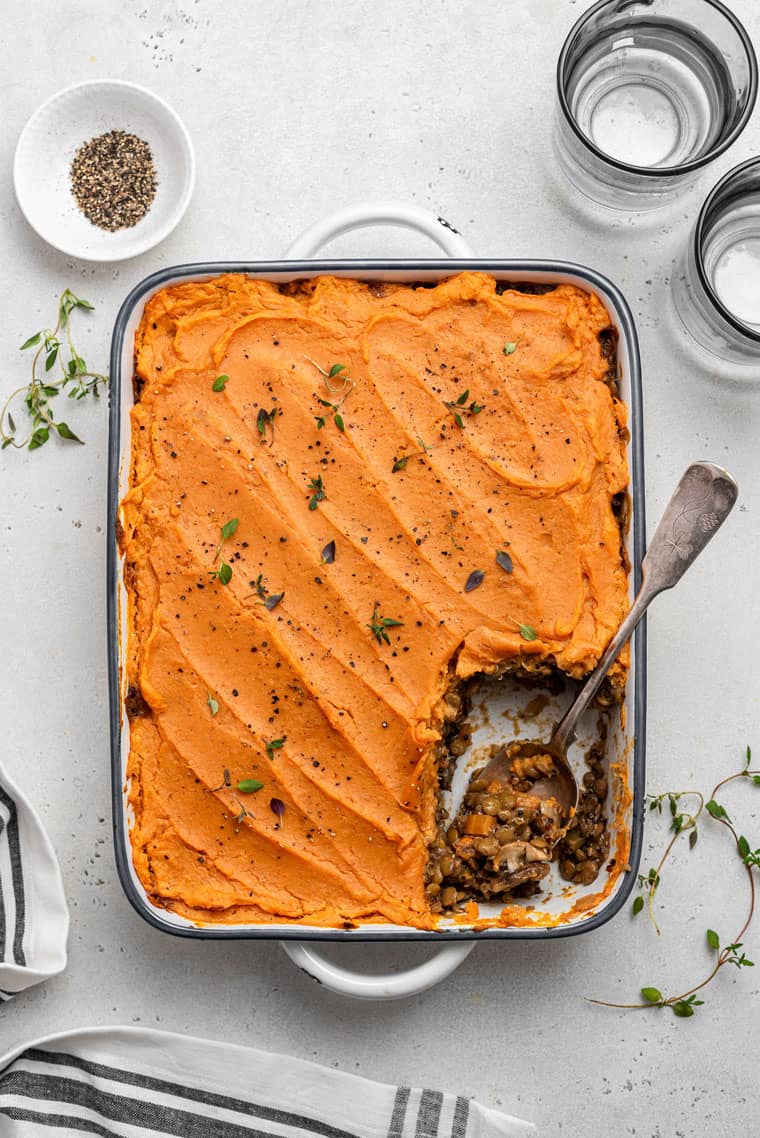 full baking dish of vegan shepherd's pie with a slice removed