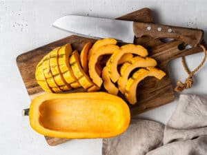 sliced delicata squash on a cutting board