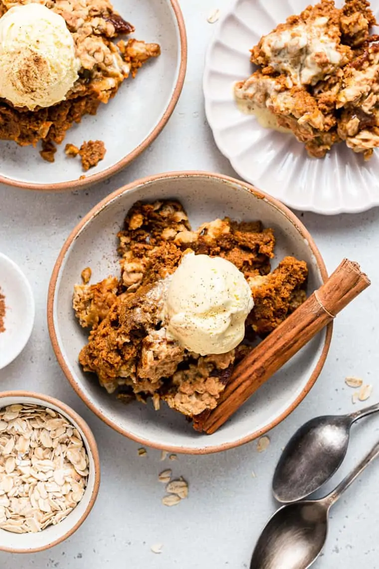 dish of pumpkin crisp with ice cream and cinnamon