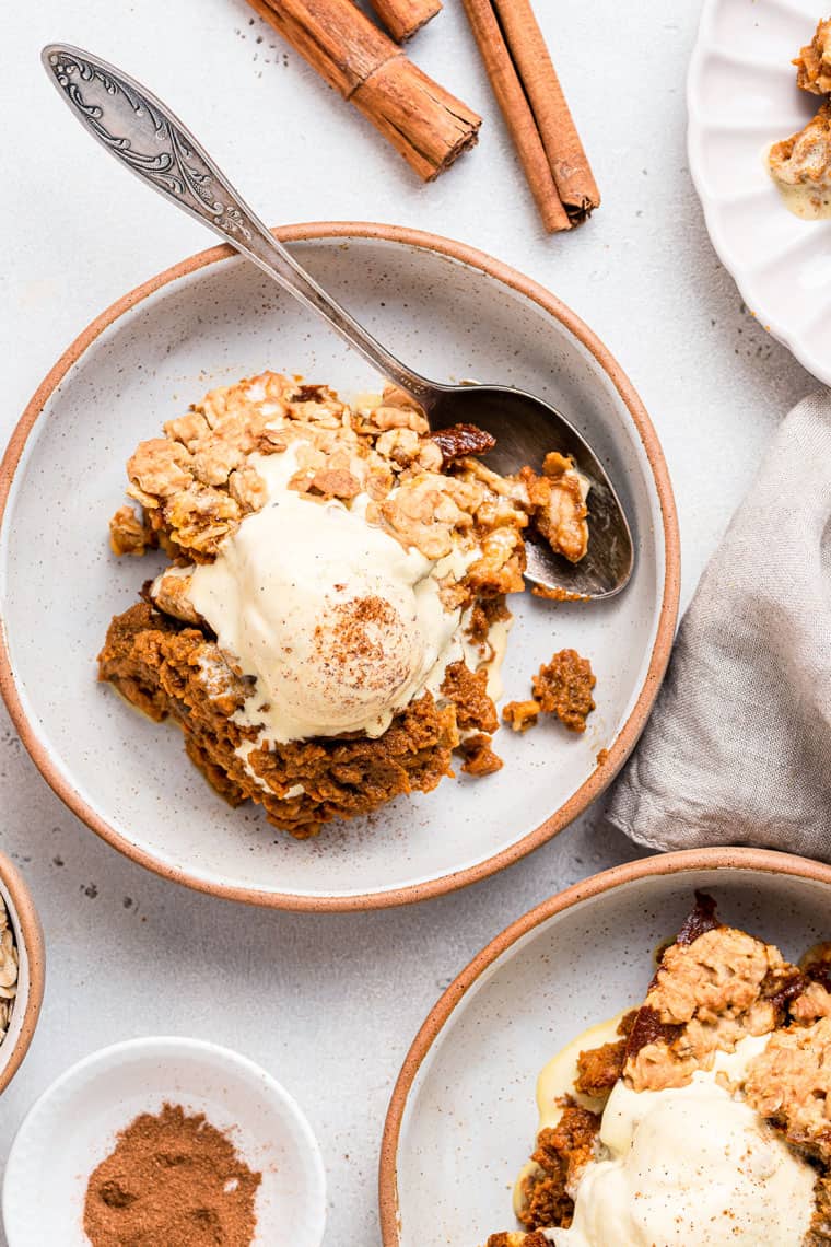 dishes of pumpkin crisp with ice cream and cinnamon
