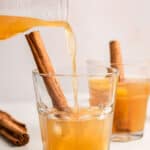 pouring lemon bourbon cocktails into a glass