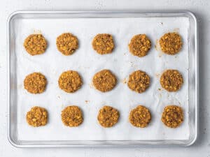 baking sheet with uncooked pumpkin cookies