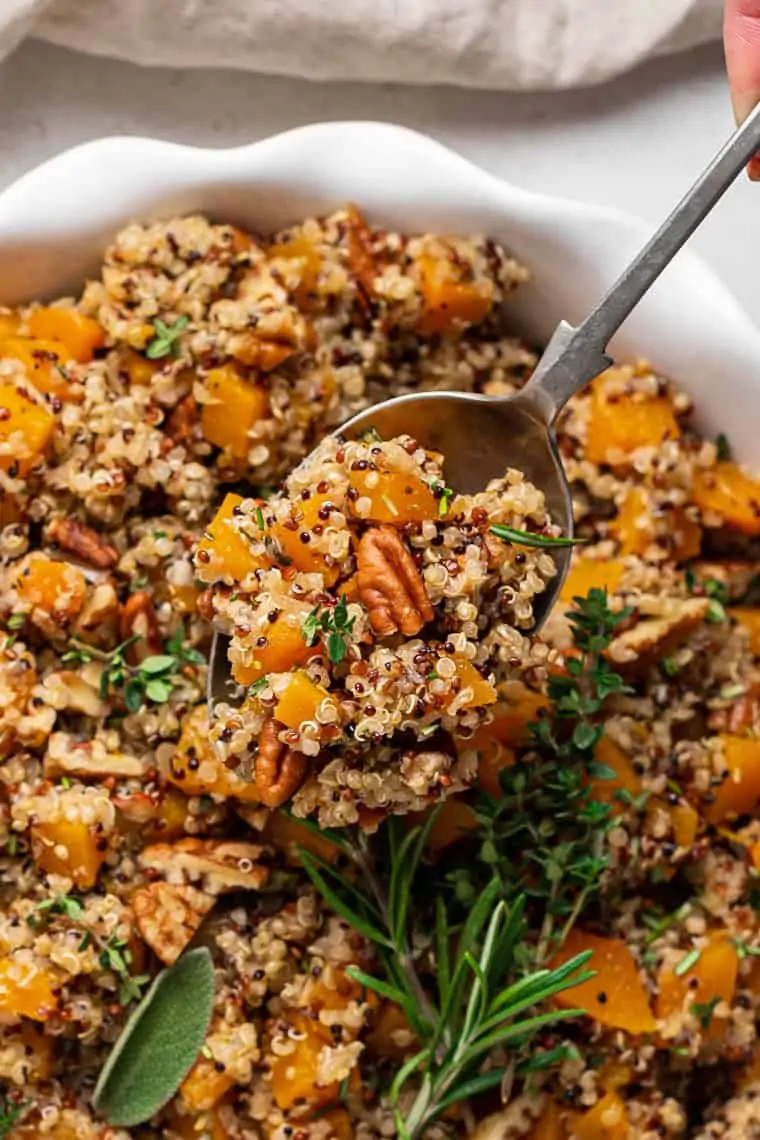 spoon holding a scoop of homemade quinoa stuffing