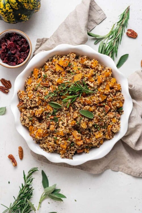 white plate of quinoa stuffing with fresh herbs