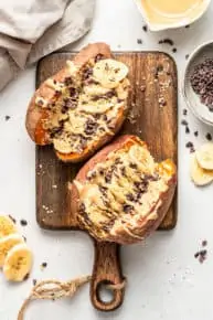 cutting board with sweet potatoes, banana and cacao nibs