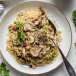 plate of mushroom quinoa with a spoon