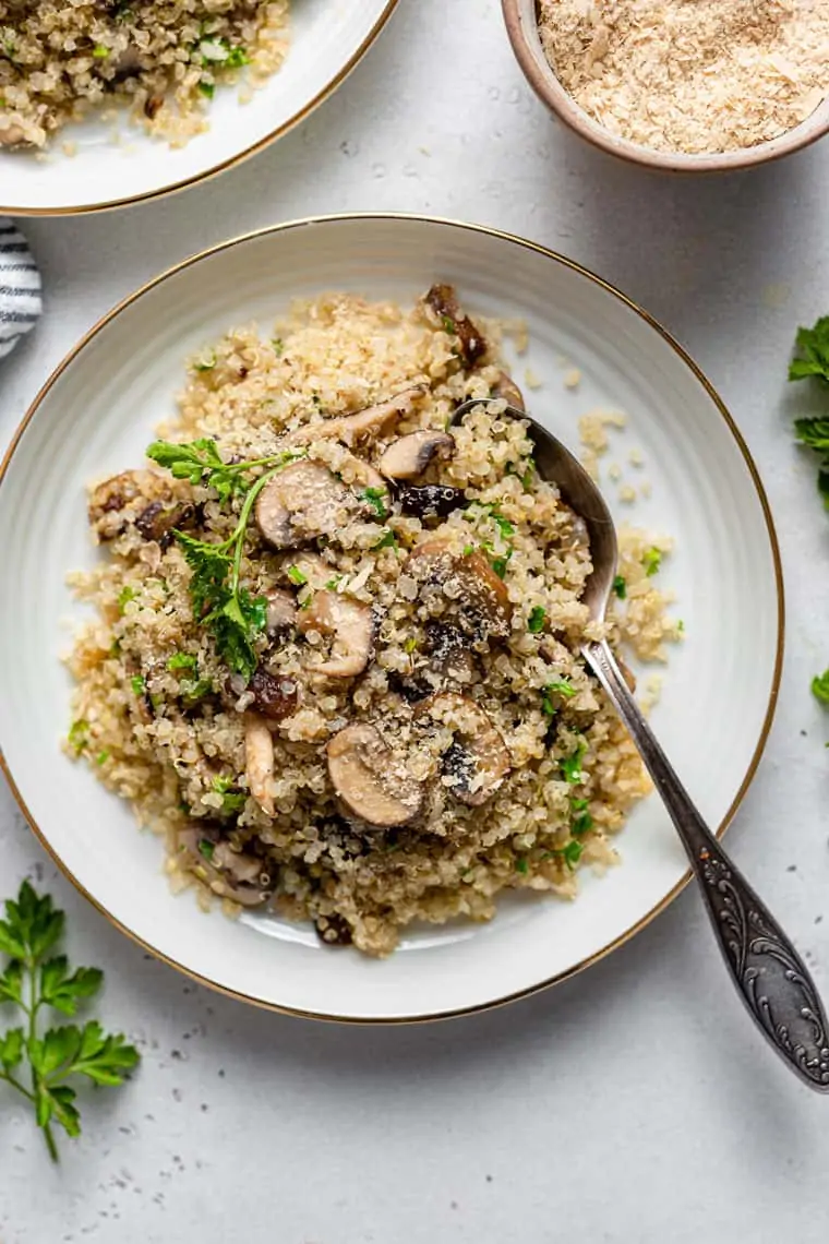 plate of mushroom quinoa with a spoon