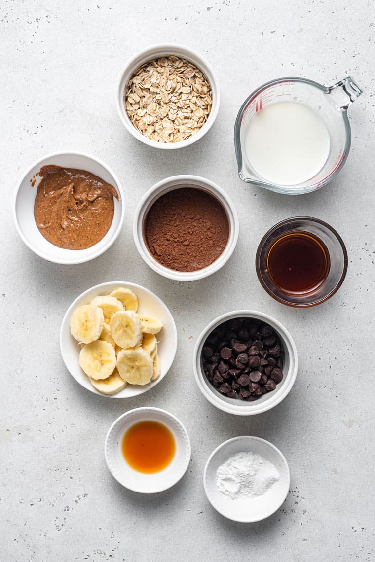 ingredients for oatmeal with chocolate, bananas, nut butter and vanilla