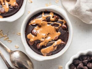 close up on a bowl of chocolate baked oatmeal with nut butter