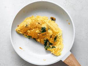 omelet with eggs and kale in a skillet
