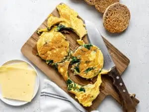 cutting omelet into circles for breakfast sandwiches