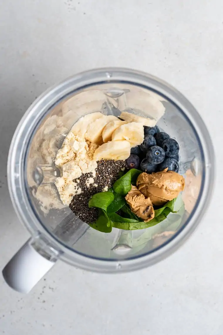 blender with blueberries, bananas and chia seeds