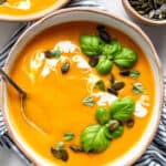 close up on a bowl of butternut squash soup with pumpkin seeds