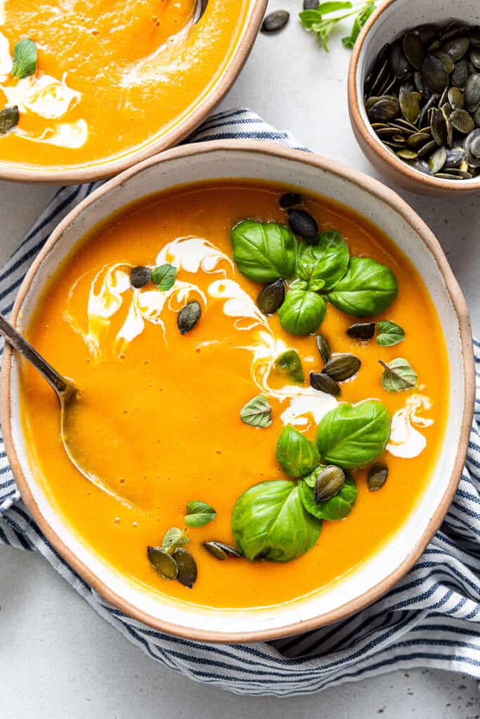 close up on a bowl of butternut squash soup with pumpkin seeds