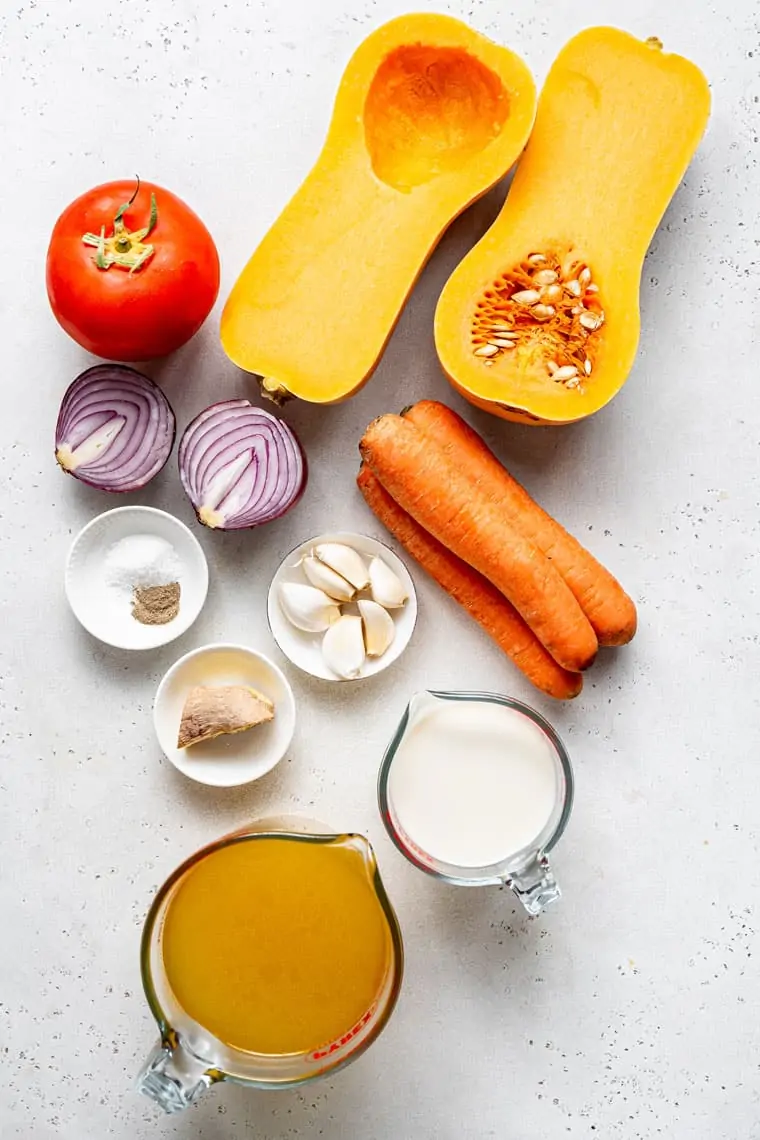 ingredients for soup with butternut squash, carrots, onion and garlic