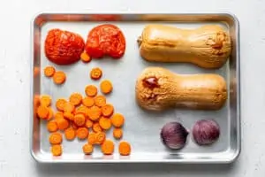 ingredients for butternut soup roasted on a baking sheet