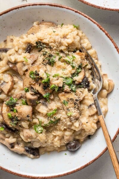 bowl of vegan mushroom risotto with fresh herbs