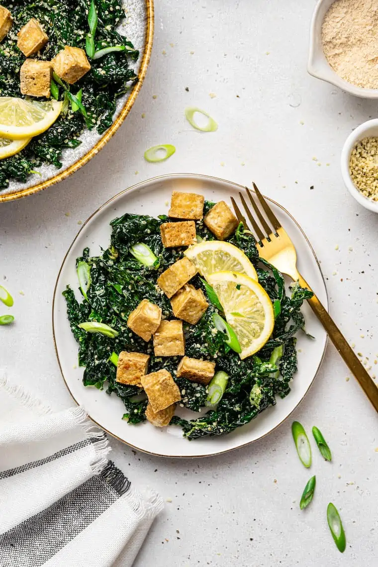 bowl of crispy tofu and kale salad with lemon