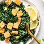 plate of kale salad with crispy tofu
