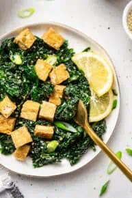 plate of kale salad with crispy tofu