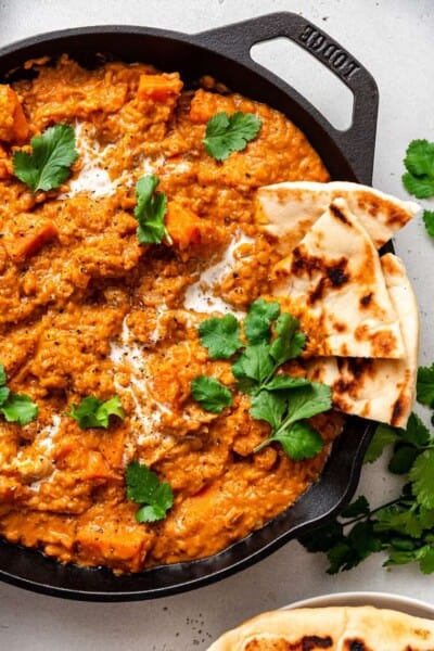 skillet of sweet potato curry with naan