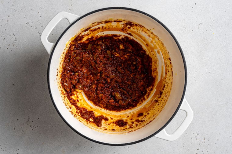 cooking curry paste in a pot