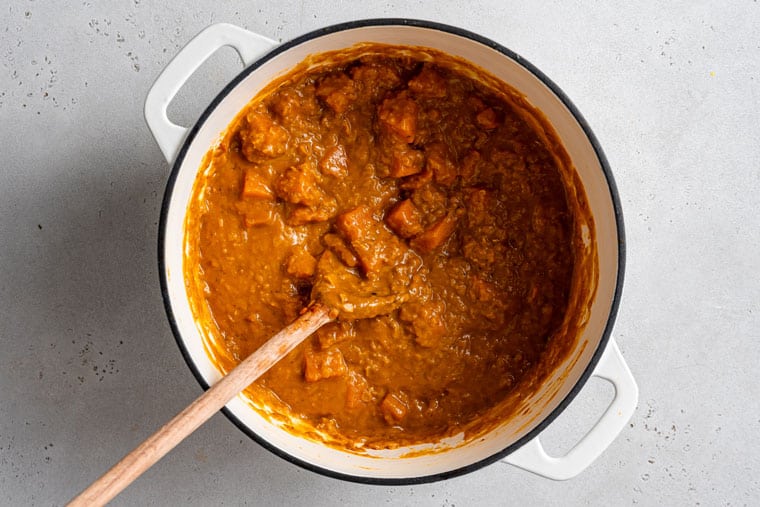 This creamy red lentil curry with sweet potatoes is a one-pot recipe that delivers lots of cozy comfort. It's an easy, filling vegan dinner! pot of red lentil curry with sweet potatoes