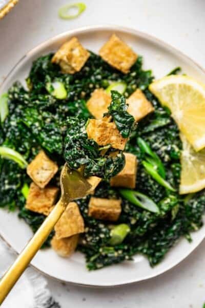 tofu and massaged kale salad on a fork