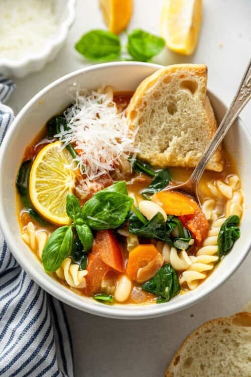 bowl of vegetable and pasta soup with bread