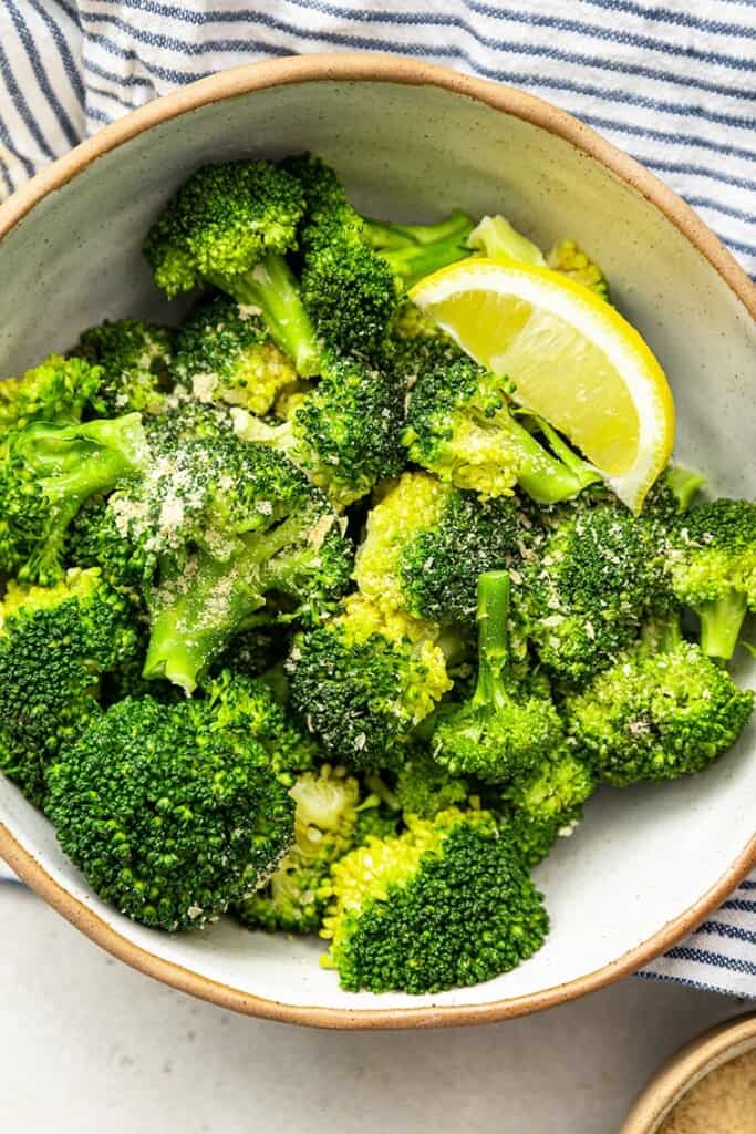 bowl of broccoli with lemon and seasoning