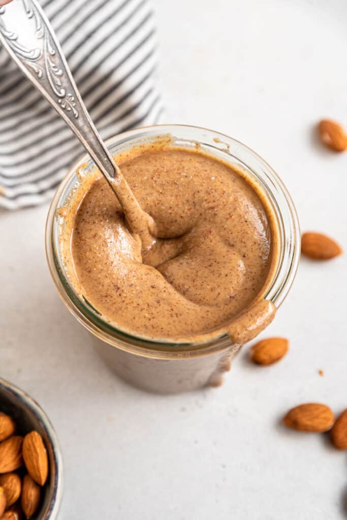 jar of homemade almond butter with a spoon