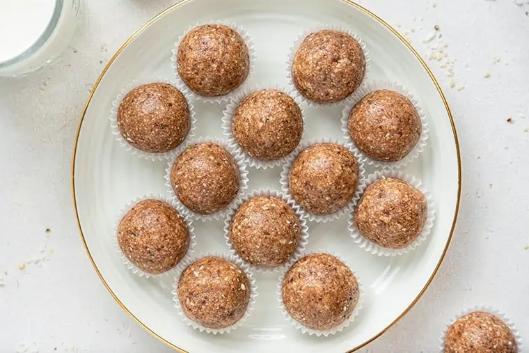 salted caramel energy bites in wrappers on a plate