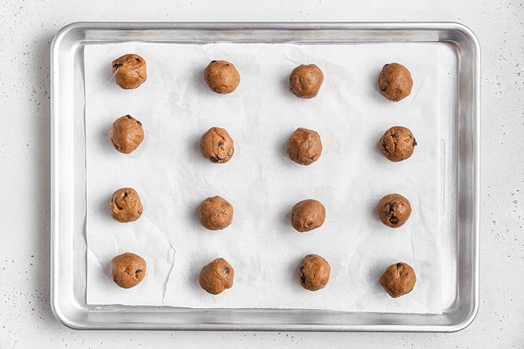 shaped chocolate chip cookies on a baking sheet