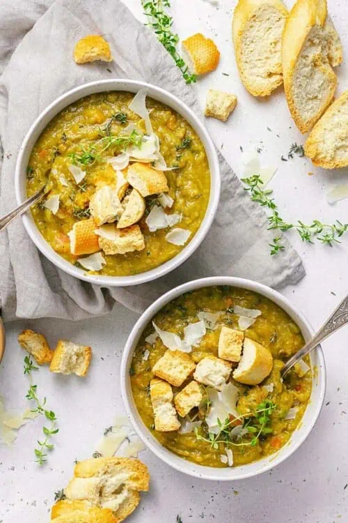two bowls of split pea soup with toasted bread