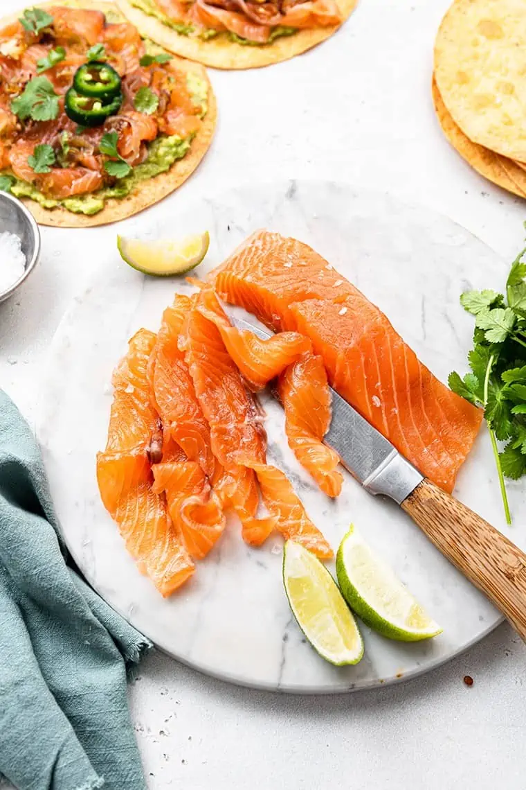 slices of cured salmon on a marble board