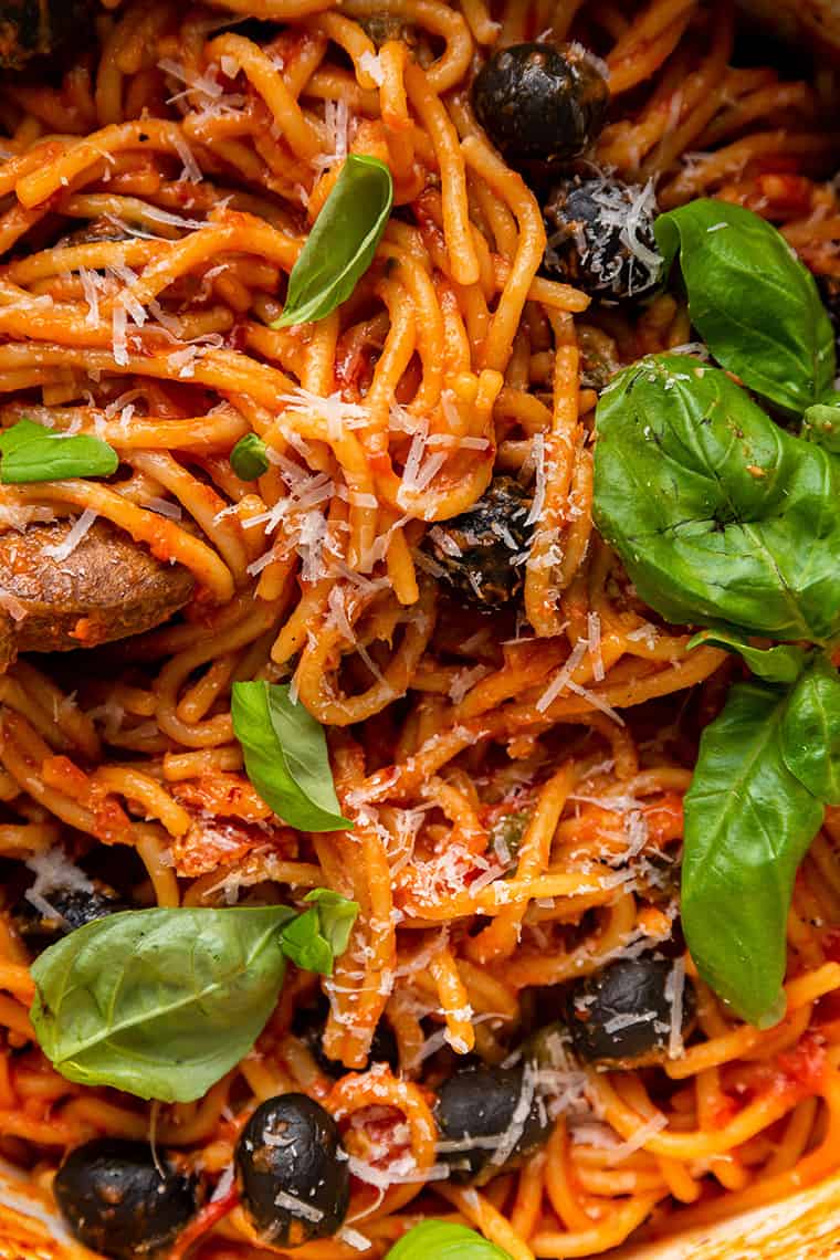close up on pasta with olivs, cheese and tomato sauce
