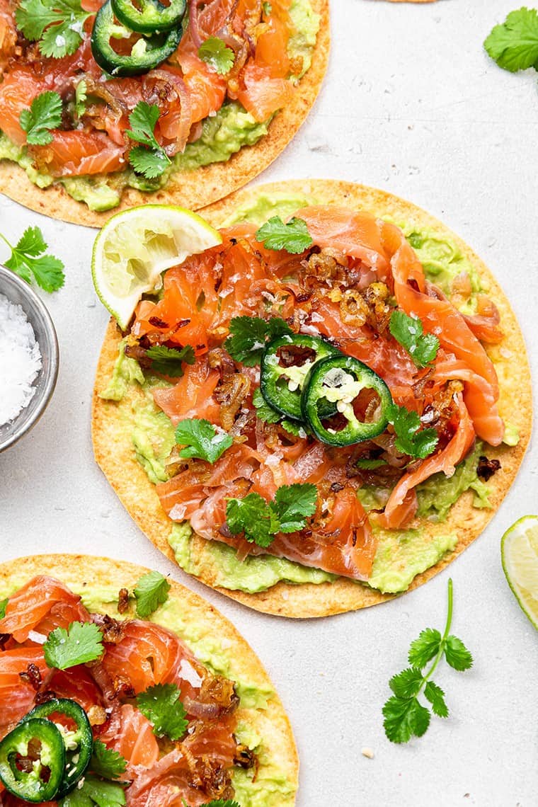 salmon tostada with mashed avocado and lime