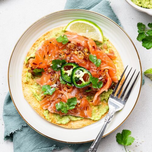 salmon tostada with mashed avocado