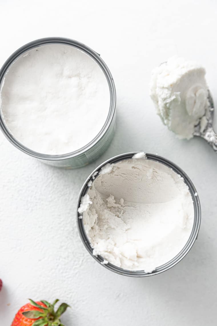 overhead of two cans of cold coconut cream