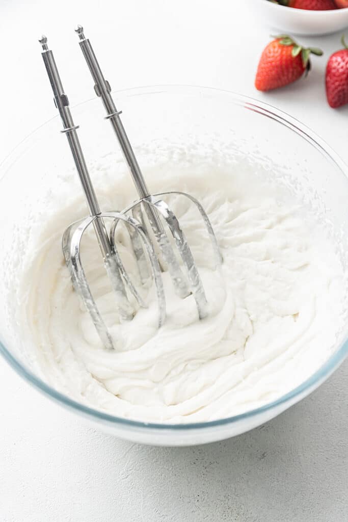 mixing bowl with whisks to make coconut whipped cream
