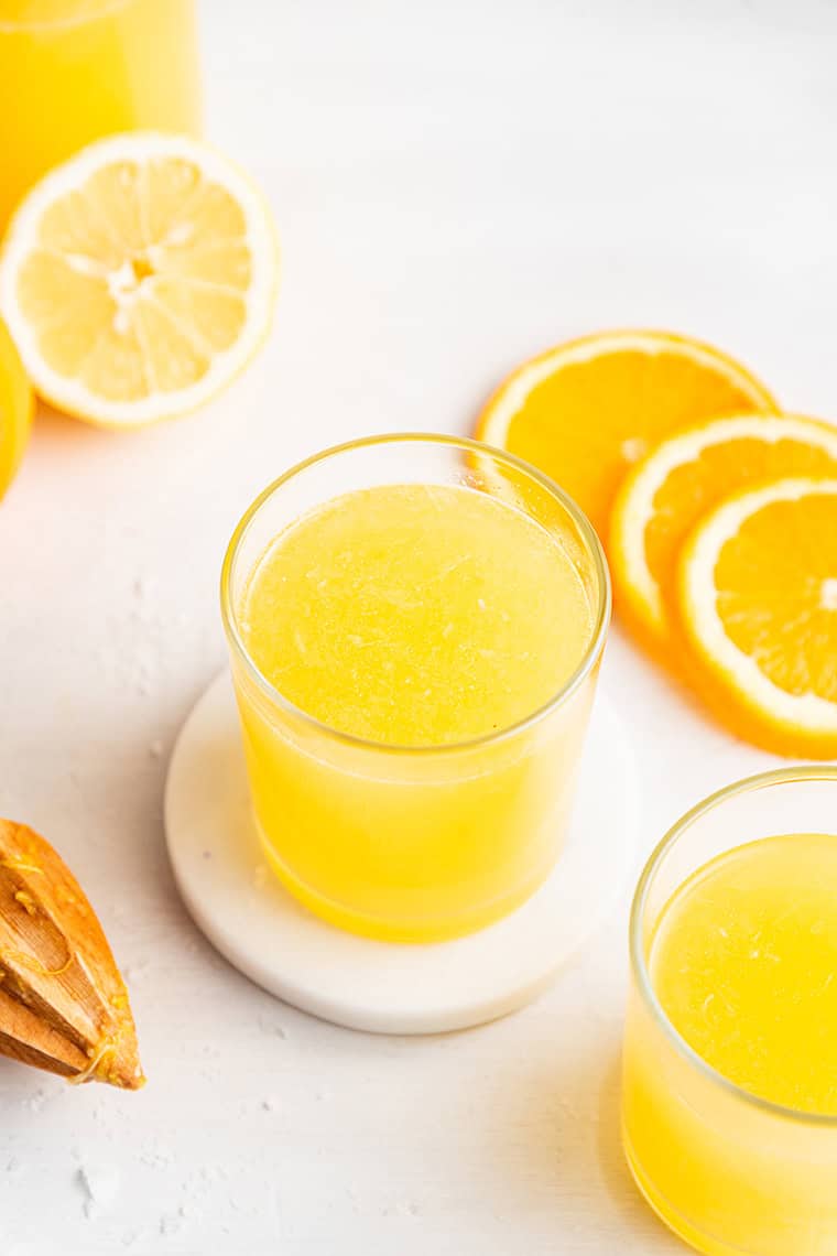 lemon drink in a glass with fresh lemon slices