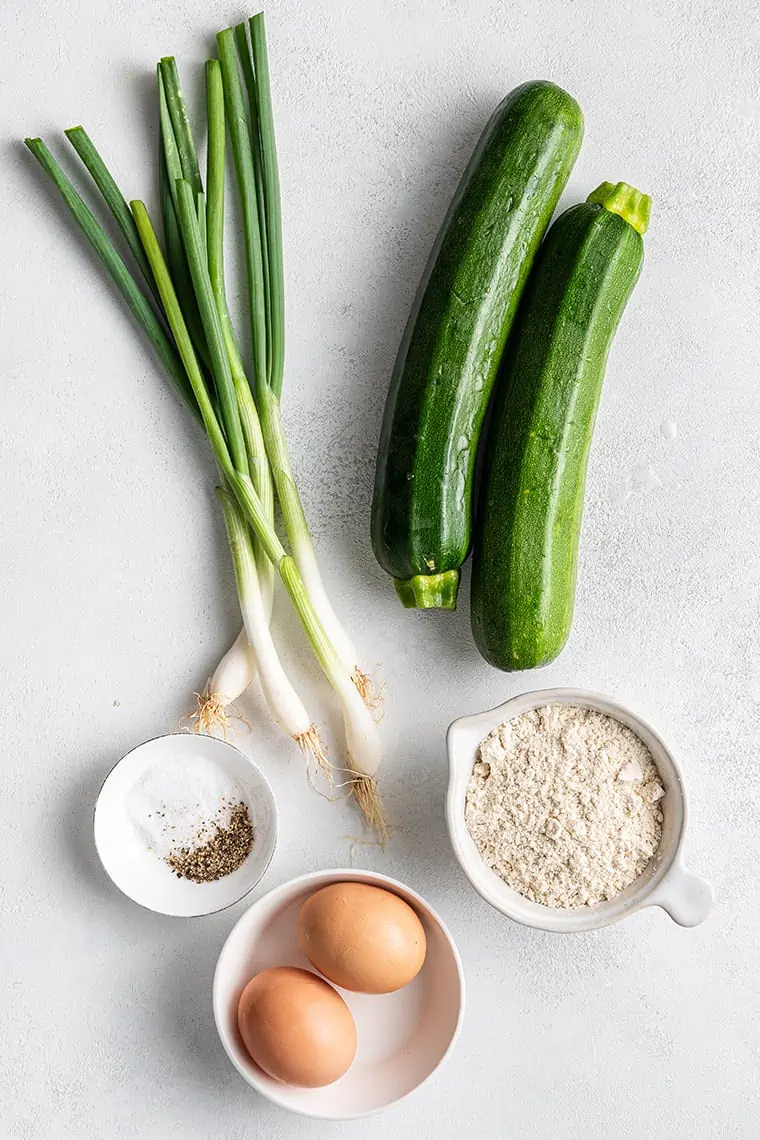 Overhead view of ingredients for zucchini fritters